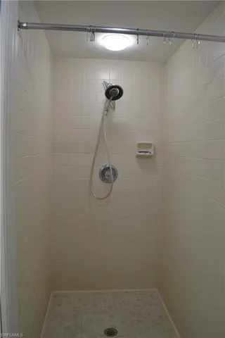 Full bathroom featuring tiled shower