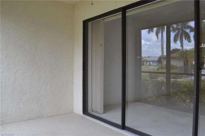Doorway to property with stucco siding and a balcony