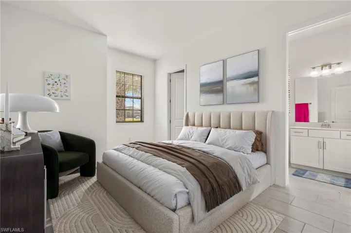 Recessed lighting, wood-finish flooring, a window with horizontal blinds, and an attached bathroom with a single vanity featuring a countertop and cabinet storage