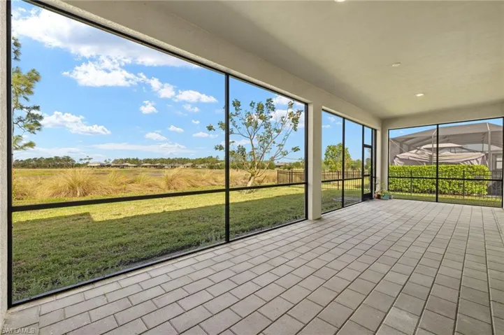 Screened lanai featuring paver flooring, recessed lighting, and expansive outdoor living space