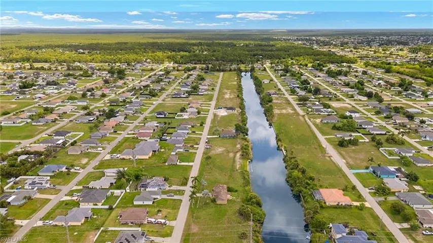 Aerial overview of property's location with nearby suburban area and a large body of water