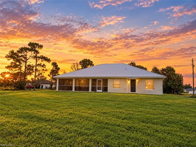 Expansive grassy yard with mature trees