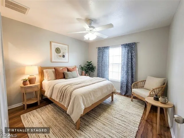 Bedroom 2 w/Arched window with ample natural light, ceiling fan, and tile flooring.