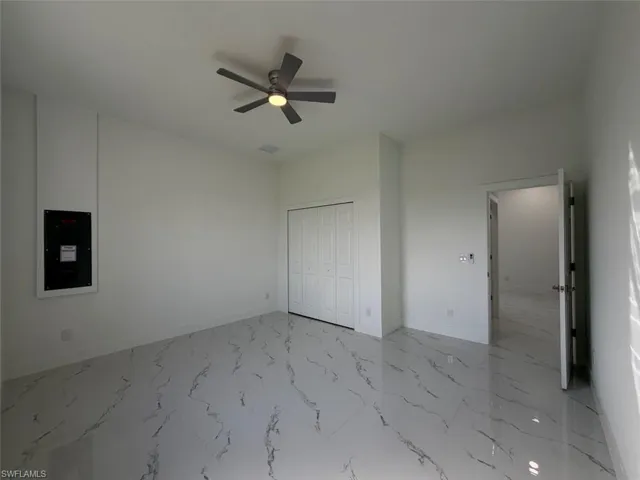 Polished tile flooring, modern ceiling fan, white bi-fold closet doors, and recessed lighting