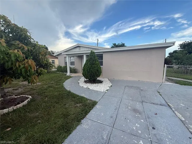 View of front of property with stucco siding and a patio area
