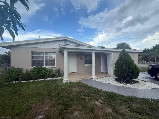 View of front of property featuring a porch and stucco siding
