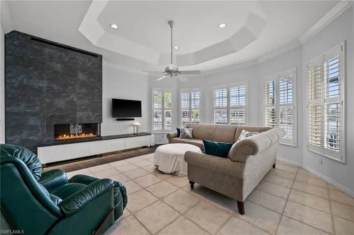 Family Room with Gas fireplace and plantation shuttered windows