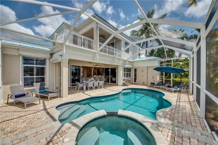 View of swimming pool featuring a sunroom, a patio, a lanai, and a pool with connected hot tub