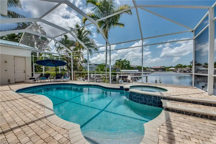 View of pool featuring a patio, a sunroom, and a lanai