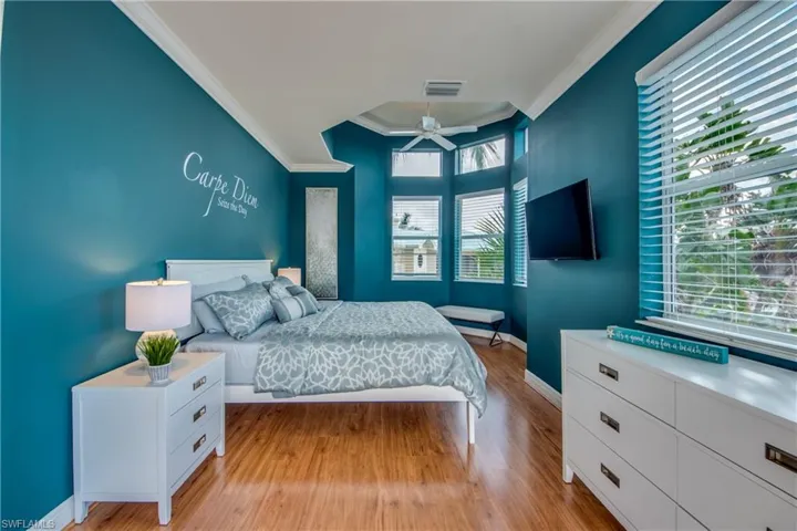 Bedroom with light wood-style flooring and ornamental molding