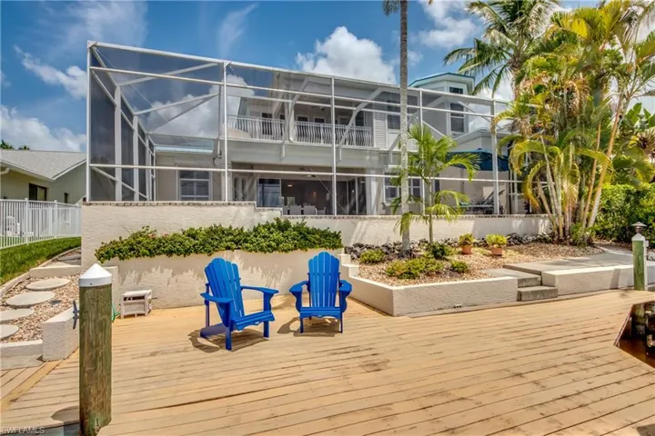 Deck featuring a sunroom and glass enclosure