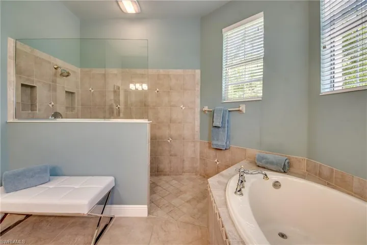 Full bath with a garden tub, walk in shower, and tile patterned floors