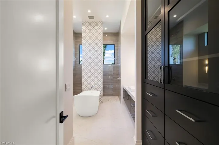 Bedroom featuring light wood-style flooring, connected bathroom, ceiling fan, and recessed lighting