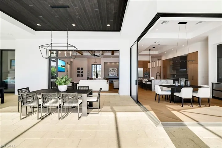 View of patio / terrace with area for grilling, a ceiling fan, a sunroom, a pool with connected hot tub, and outdoor lounge area