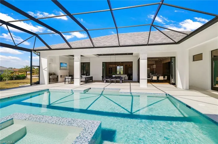 Integrated pool / spa featuring a sunroom, a lanai, and a patio area