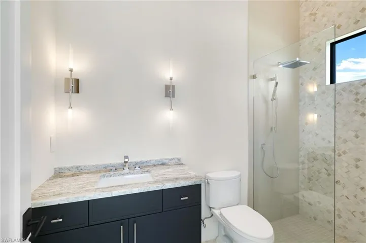 Bathroom featuring vanity and wallpapered walls
