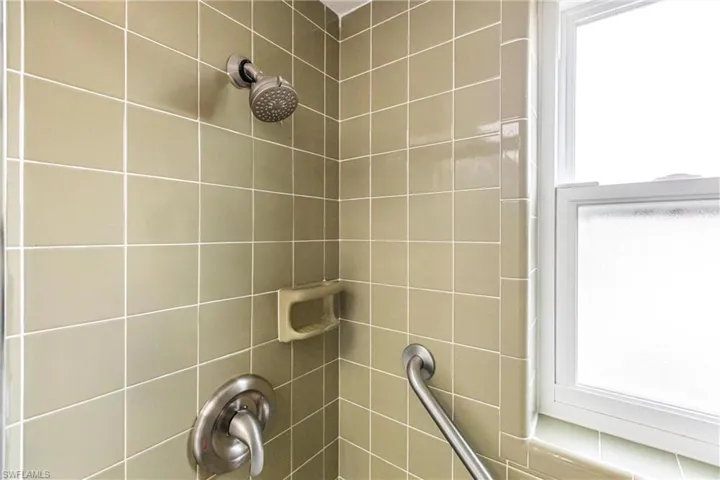 Interior details featuring a tile shower