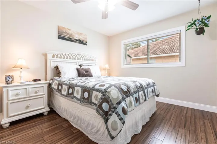Bedroom with ceiling fan and dark hardwood / wood-style flooring