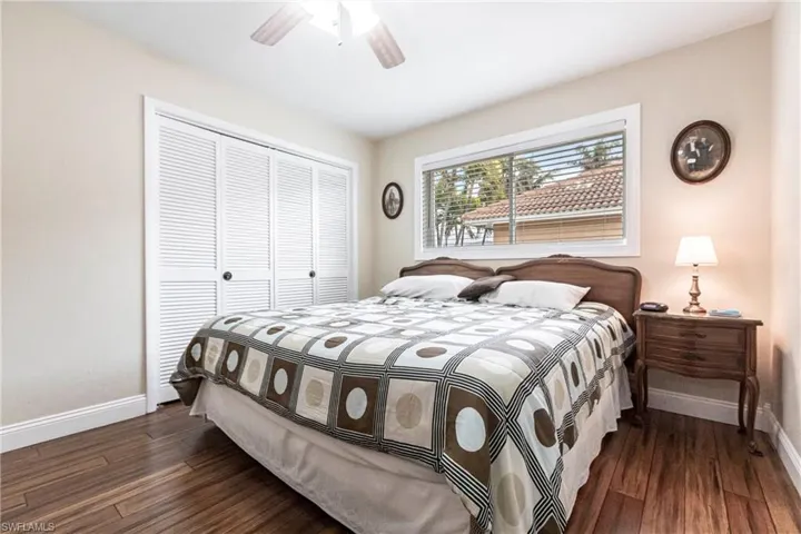 Bedroom featuring a closet, ceiling fan, and dark wood-type flooring