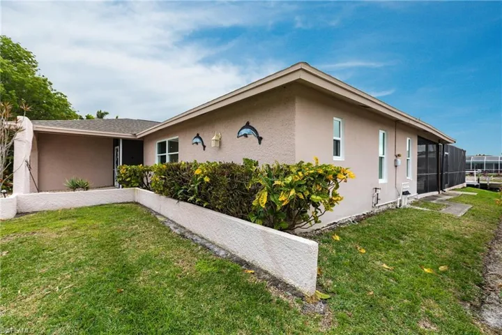 View of property exterior with a yard