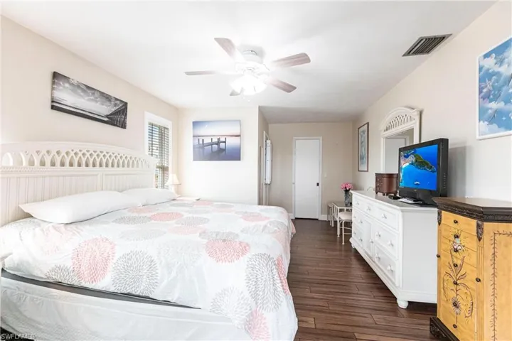 Bedroom featuring ceiling fan and dark hardwood / wood-style floors