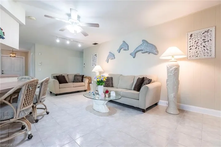 Living room featuring ceiling fan and light tile patterned floors