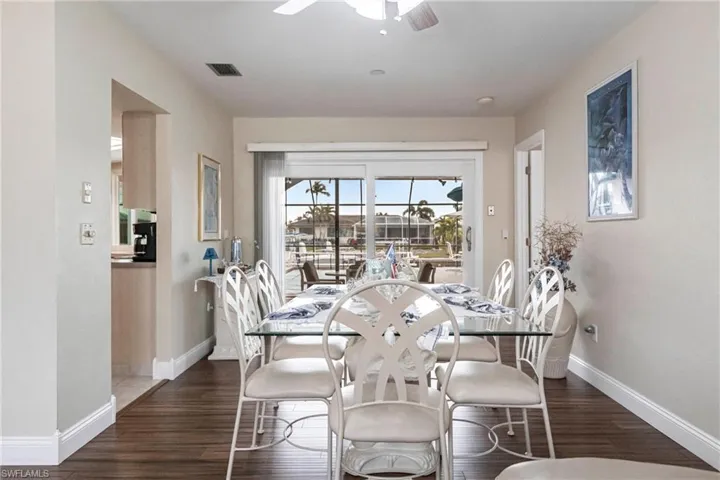 Dining area with ceiling fan and dark hardwood / wood-style floors