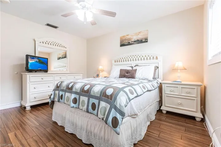 Bedroom featuring dark hardwood / wood-style floors and ceiling fan
