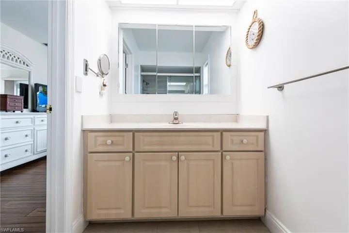 Bathroom with vanity and a shower with door