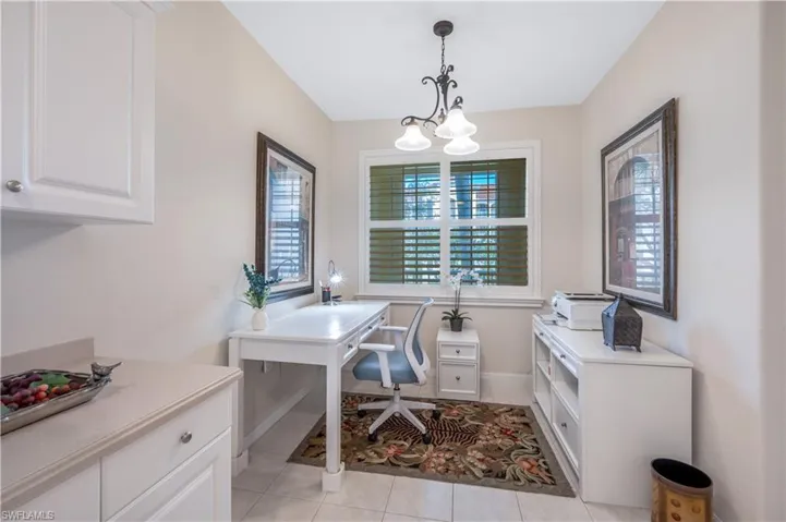 Office featuring baseboards and light tile patterned flooring