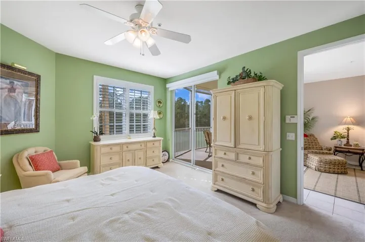 Bedroom featuring access to exterior, light carpet, ceiling fan, and baseboards