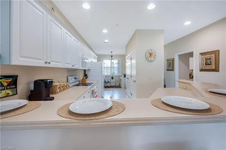 Bathroom with a notable chandelier and recessed lighting