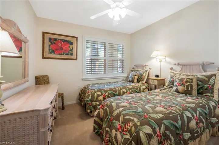 Bedroom with a ceiling fan, carpet, and baseboards