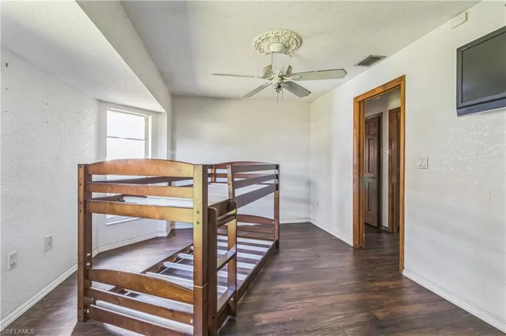 Bedroom featuring dark wood-type flooring and ceiling fan