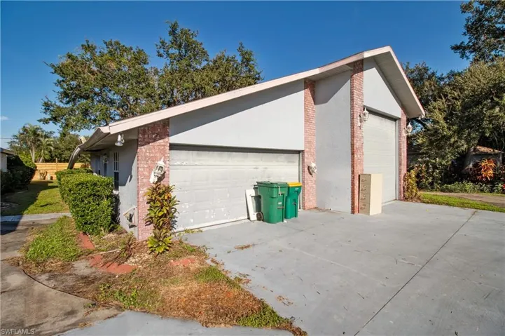 View of side of property with a garage