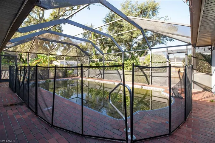 View of pool featuring a water view, a patio area, and a lanai