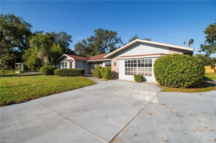 Single story home featuring a front lawn