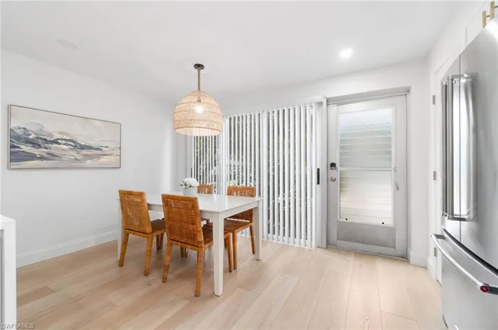 Dining space with light wood-style floors and baseboards