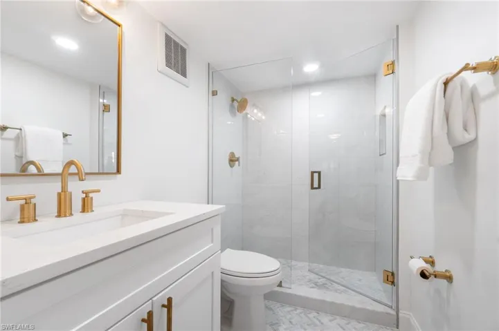 Full bath with vanity and a shower stall