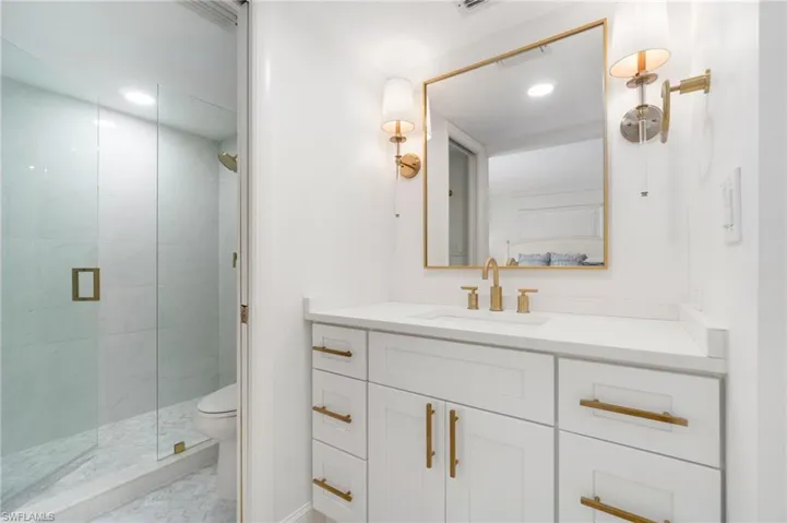 Full bath with vanity, a shower stall, and recessed lighting