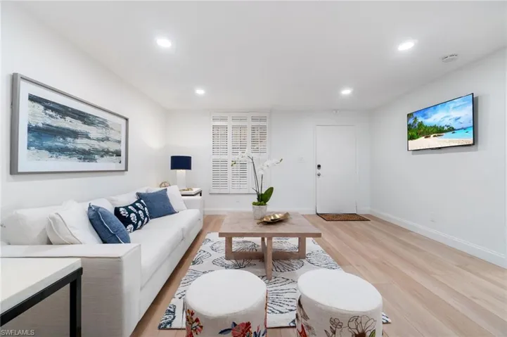 Living area featuring light wood-style flooring and recessed lighting