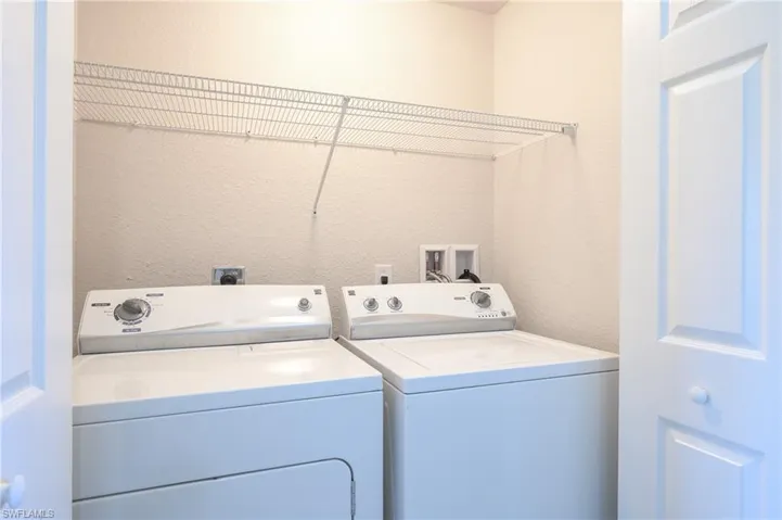 Washroom area featuring washer and dryer