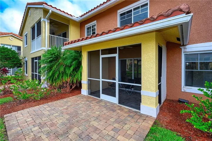 Lakefront paver patio area with attached screened in lanai