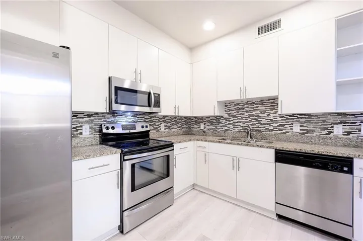 Kitchen with stainless steel finishes, and backsplash.