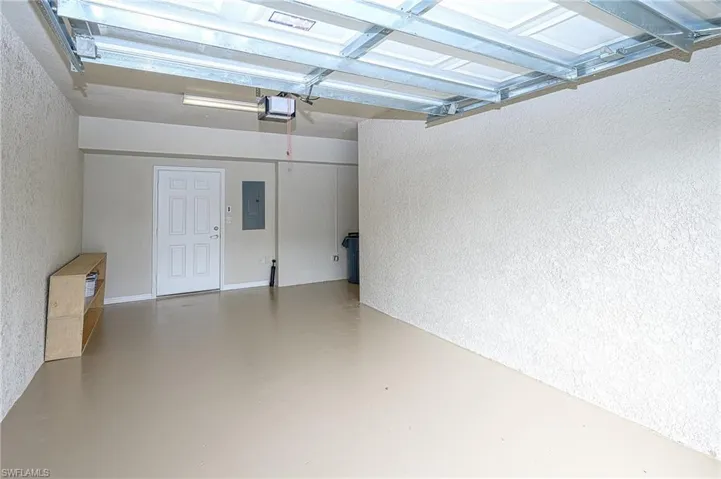 Garage with electric panel and a garage door opener