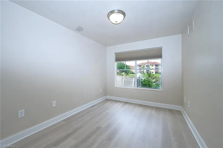 downstairs lakefront bedrroom featuring light hardwood / wood-style flooring