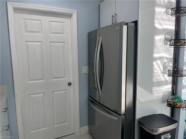Kitchen with an inviting chandelier and freestanding refrigerator