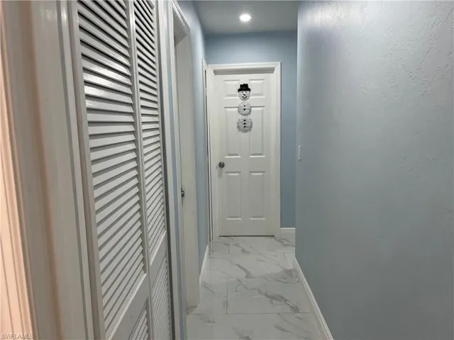 Hall featuring marble finish floor and baseboards