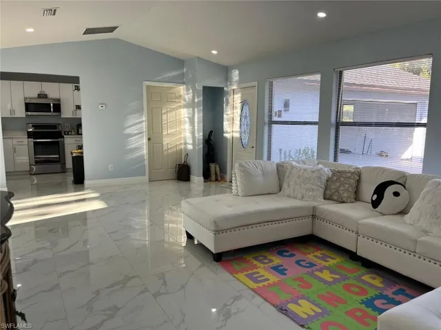 Living room with lofted ceiling