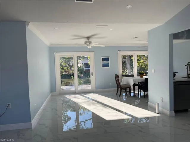Dining area featuring french doors, ceiling fan, and crown molding